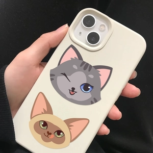 Detail of matte cream phone case featuring cute cartoon cat illustrations in hand