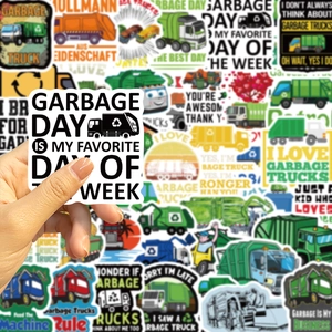 Close-up of waterproof garbage truck stickers for laptops and guitars featuring fun slogans