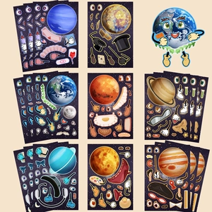 Detail of DIY planet stickers with faces, limbs, and accessories for scrapbooking craft