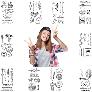 Detail of waterproof temporary tattoo stickers with minimalist black line art on skin