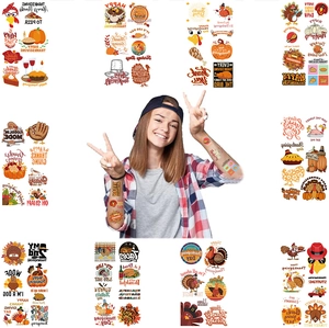 Close-up of Thanksgiving temporary tattoos with turkey, pumpkin and autumn leaf patterns