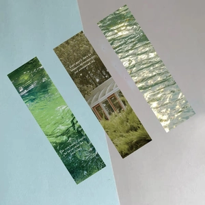 Detailed view of aesthetic forest bookmarks with nature photography and white quotes