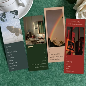 Close-up of four artistic photography bookmarks on green velvet with a coffee cup