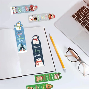 Detailed view of creative Christmas bookmarks with festive cartoon characters on a desk