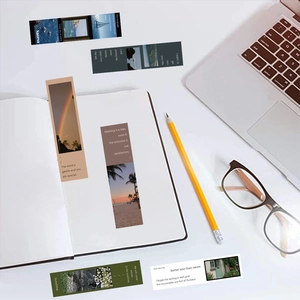Macro view of aesthetic landscape bookmarks with inspirational quotes and stationery items