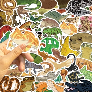 Macro shot of a colorful frog sticker held by hand from a reptile and lizard decal set