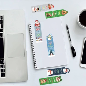 30pcs Cartoon Christmas paper bookmarks with Santa, deer and bear patterns on a desk