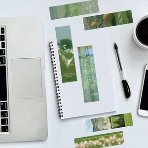 Close-up of artistic nature bookmarks featuring forest scenes and white typography