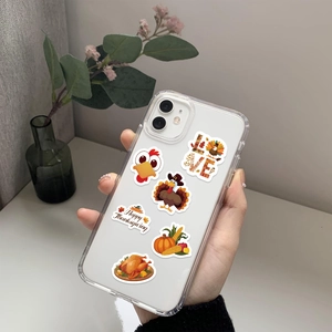 Close-up of Thanksgiving turkey and pumpkin stickers on a clear iPhone case