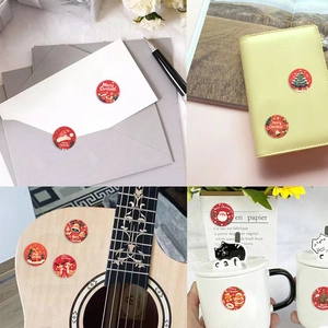 Close-up of Christmas stickers on envelopes, journals, guitars, and mugs for decor