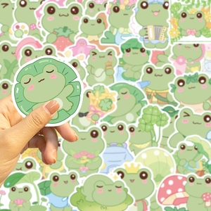 Close-up of waterproof cartoon frog stickers being held to show size and quality