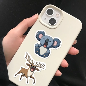 Handheld shot of cream iPhone case with cartoon koala and reindeer illustration detail