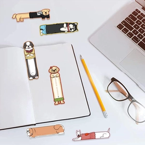 Flat lay of cute long-bodied puppy bookmarks on a desk with glasses and stationery