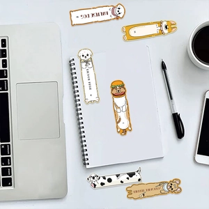 Close-up of cute cartoon dog bookmarks and stickers on a desk with creative stationery items