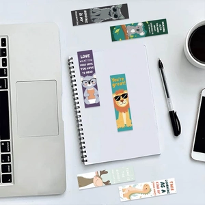 Detailed top view of cartoon animal bookmarks with inspirational quotes on a white desk