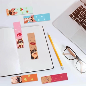 Creatieve hondenbladwijzers met schattige puppyontwerpen op een schrift en laptop
