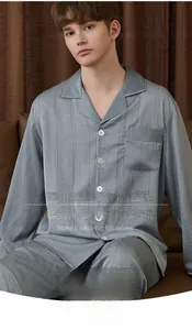 Detail of grey silk pajama set with satin piping and fine micro-plaid texture