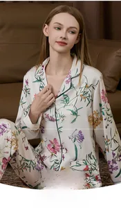 Close-up of elegant floral silk pajamas set with long sleeves on indoor model