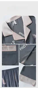 Detail view of charcoal silk pajamas showing the collar, pocket, stitching and elastic waistband