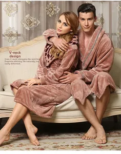 Close-up of the plush coral fleece material and V-neck design on the pink bathrobe