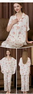 Detailed close-up of silk pajamas featuring sun and moon prints with brown piping and pockets