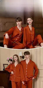 Classic rust red silk pajama set with white piping and button-down design for couples