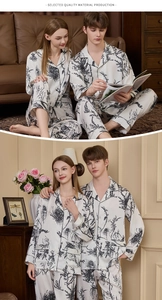 Detail of silk pajamas featuring black floral patterns and contrast piping on the collar