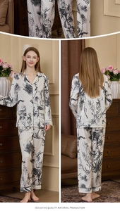Close-up of women's silk satin pajama set with black floral print and contrast piping