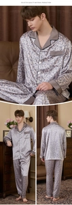 Close-up of men's silver silk pajamas with dark tropical leaf patterns and piping details