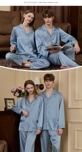 Close-up of light blue silk pajamas with stylish contrast piping and buttons