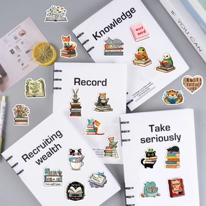 Close-up of animal reading stickers on notebooks showing creative cartoon illustrations