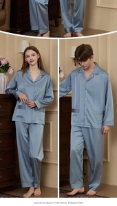 Detail view of light blue satin pajamas showing premium piping and smooth silk texture