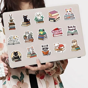 Close-up of waterproof animal reading stickers on a laptop with vibrant hand-drawn designs