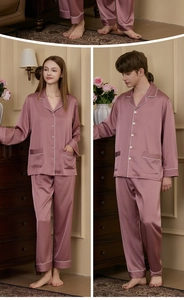 Detail of silk satin pajamas featuring elegant white contrast piping and smooth texture