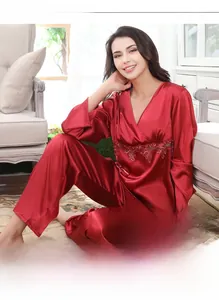Detail of red satin pajamas with delicate lace embroidery and smooth silky texture