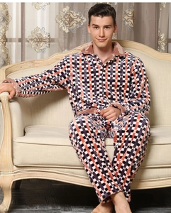 Detail of men's flannel pajama lapel and soft fleece texture in orange plaid