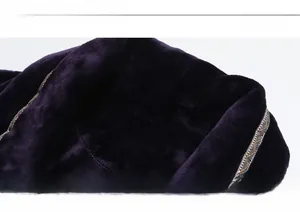 Detailed view of dark purple flannel robe with shawl collar and intricate geometric embroidery
