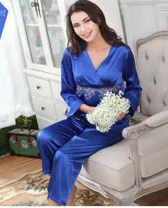 Detail of royal blue silk pajamas with intricate lace trim on the V-neck and sleeves