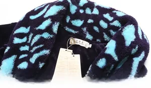 Macro detail of plush flannel bathrobe shawl collar with blue animal print and soft texture