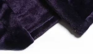 Macro shot of dark purple flannel bathrobe hem with smooth stitching and soft texture