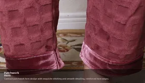 Detailed close-up of burgundy waffle fleece pants featuring velvet hem stitching finish