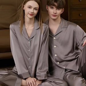 Matching couple's silk pajama sets in elegant mauve grey with premium piping detail