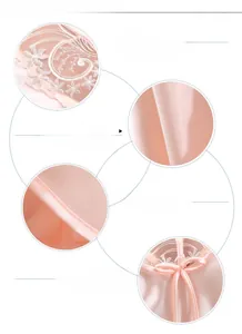 Detail eines rosa Seidenpyjamas mit Spitzenbesatz und zarter Schleife am Ausschnitt