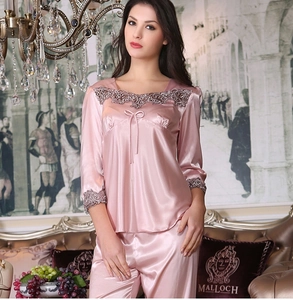 Detailed view of pink silk satin pajama set with purple lace embroidery on cuffs and collar