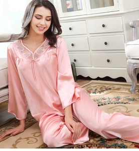 Detailansicht der rosa Seidenpyjamas mit zarter weißer Spitze und V-Ausschnitt-Design