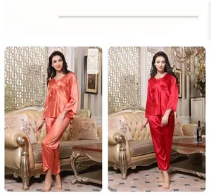 Detail display of silk pajamas showing orange-red and red sets with lace embroidery