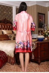 Detail of pink silk satin floral robe with peony print on sleeves and back hemline