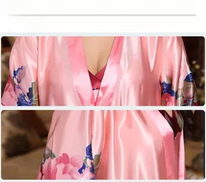 Detailed view of women's pink silk satin bathrobe featuring elegant peony floral patterns