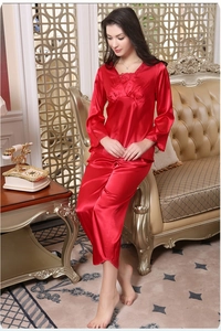 Lace detail on red satin pajama top with V-neckline shown in luxury home setting
