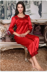 Lace detail on red satin long-sleeve pajama set with drawstring neckline in luxury room